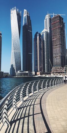 some very tall buildings by the water