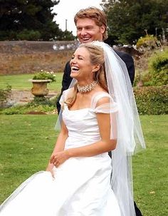 the bride and groom are laughing together outside