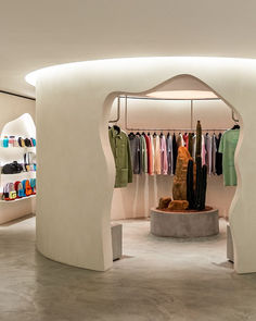 the inside of a clothing store with clothes on display