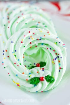 a white plate topped with green frosting and sprinkles