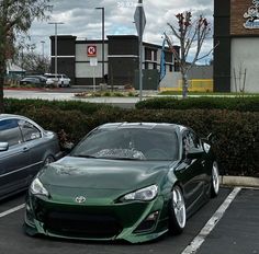 two cars parked next to each other in a parking lot