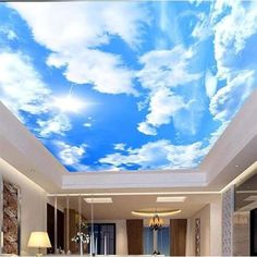 the ceiling is decorated with blue sky and white clouds in this living room, it looks like an art work