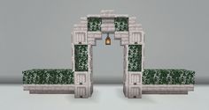 an arch made out of blocks and grass with a light at the end on top