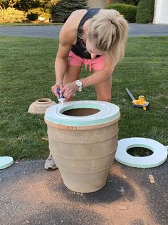 a woman is making a pot out of clay