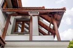 the corner of a building with an open window on it's side and wood trim around the windows