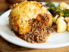 a close up of a plate of food with broccoli and other foods on it