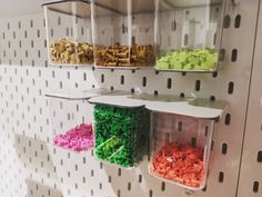 there are three bins with different types of beads on the wall next to each other