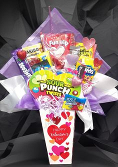 the candy bouquet is filled with lots of candies and lollipops for valentine's day