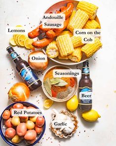 an image of food that includes corn on the cob, potatoes and hot dogs