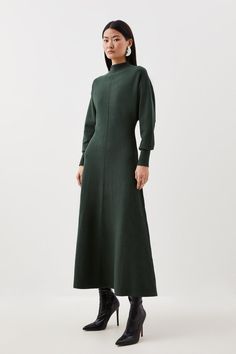 Compact Knit Wool Look Full Skirt Midaxi Dress - Green - Remain elegant and cosy in this knit dress, crafted from sumptuous wool knit for a delicate touch. A funnel neck and cuffed sleeves add classic detailing, while a full skirt flares to a midaxi length, making this the idyllic dress choice for cooler days. Pair this piece with heeled boots for a sophisticated ensemble that can be worn from day to night.Long SleevesWoolFull skirtFunnel neck Shabbat Outfit, Jersey Dress Outfit, Sweater Women Outfit, Warm Winter Dresses, Long Tube Dress, Green Knit Dress, Woolen Dresses, Modest Fashion Hijab, Winter Dress Outfits