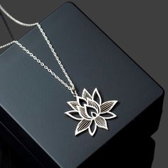 Elevate your style with the exquisite Lotus Flower Necklace from Sussex Home, a symbol of purity and grace. This sterling silver pendant is meticulously handcrafted in our workshop, ensuring each piece is a unique testament to artisan skill.

- Material: Sterling Silver
- Color: Silver
- Gender: Female
- Age Group: Adult

Ideal for bridesmaids, friends, or as a cherished gift to yourself, this necklace represents elegance and sophistication. To maintain its luster, avoid exposure to heat and har Spiritual Sterling Silver Flower Shaped Jewelry, Spiritual Flower Pendant Jewelry For Mom, Spiritual Sterling Silver Flower Jewelry, Spiritual Flower Pendant Jewelry Gift For Mom, Elegant Handmade Flower Charm Necklaces, Elegant Nickel-free Necklace For Mom, Nature-inspired Rose Gold Jewelry Gift, Spiritual Flower Shaped Jewelry Gift, Spiritual Flower-shaped Jewelry Gift