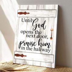 a wooden sign that says, until god opens the next door, praise him in the hallway