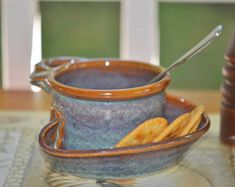 a bowl with some crackers in it on a table