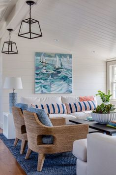 a living room with white walls and blue rugs on top of the wooden floor