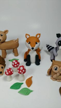 small toy animals and mushrooms on a white surface