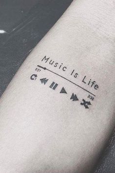 a person with a tattoo on their arm that reads music is life and arrows are all around