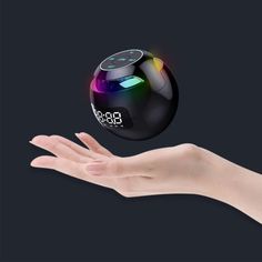 a person's hand reaching out towards an alarm clock that is floating in the air