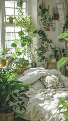 a bed covered in lots of green plants