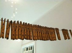 several pieces of wood are hanging from the ceiling