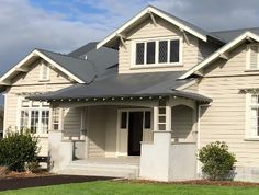 a house with white trim and gray roof