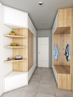 an empty hallway with wooden shelves and white walls