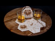 two glasses sitting on top of a wooden table next to a coaster and bottle opener