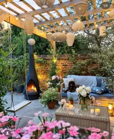 an outdoor living area with flowers and candles