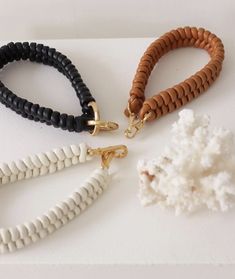 three different bracelets on a white surface