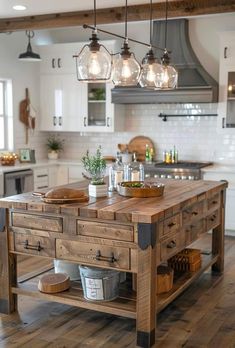 a kitchen island made out of wood with hanging lights above it and jars on the counter