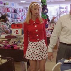 a man and woman are walking through a store