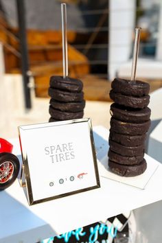 some cookies are stacked on top of each other near a sign that says spare tires