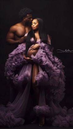 a man and woman in purple dress posing for the camera with their arms around each other