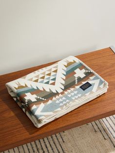 a blanket sitting on top of a wooden table