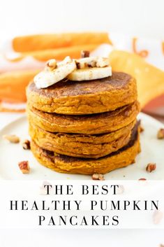 the best healthy pumpkin pancakes on a white plate with text overlay that reads, the best healthy pumpkin pancakes