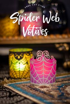 spider web votives are sitting on top of a rug with candles in the background