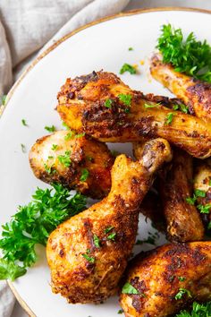 grilled chicken wings with parsley on a white plate