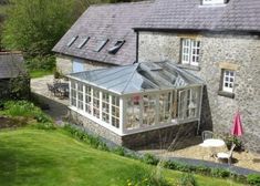 a house that has a glass roof in the yard