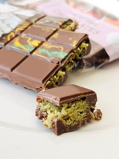 a chocolate bar sitting on top of a white plate next to a bag of candy