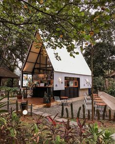 a small house with a roof that is made out of metal and has an open patio area