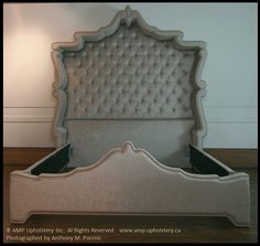 an upholstered bed frame with buttons on the headboard