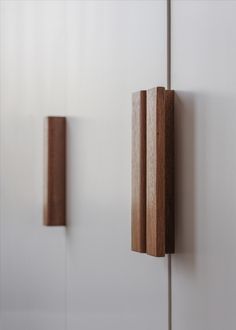 two pieces of wood are hanging on the wall