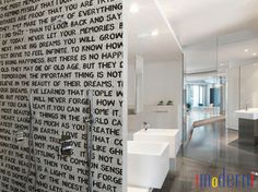 a bathroom with black and white words on the wall