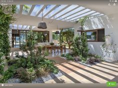 the inside of a house with lots of greenery on the walls and flooring