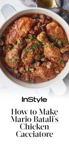 a white bowl filled with meat and vegetables on top of a marble table next to a spoon