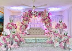 a wedding stage decorated with pink and white flowers