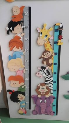 children's growth chart with cartoon animals on it and a ruler for measuring height