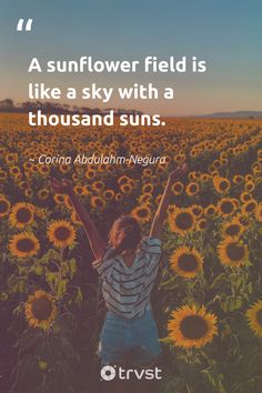 a woman standing in a field of sunflowers with her arms up and the words, a sunflower field is like a sky with a thousand suns