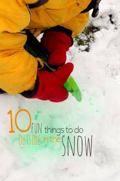 a person in yellow jacket and red gloves playing with snow