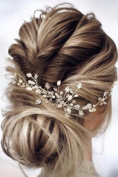 a woman with blonde hair wearing a wedding hairstyle