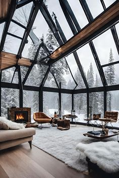 a living room filled with furniture and a fire place in the middle of a snow covered forest